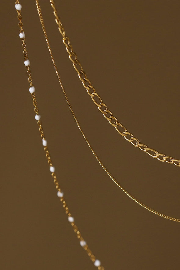 three layered 18K gold necklace pearl details