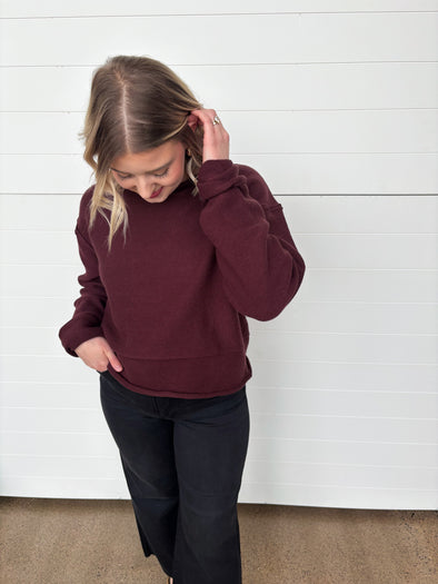 burgundy crew neck sweater with rolled edge detailing
