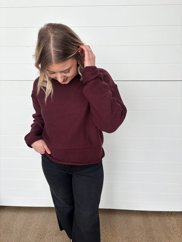 burgundy crew neck sweater with rolled edge detailing
